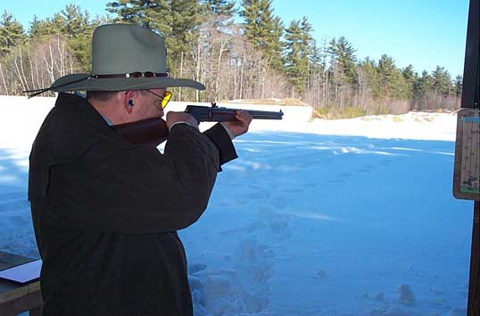 Bearing down with the lever action rifle.